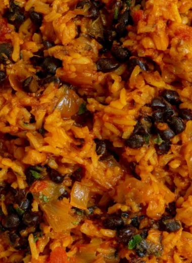 Plate of black beans and rice garnished with herbs and spices