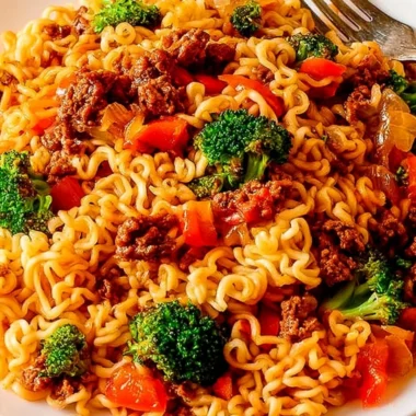 Cozy beef ramen noodles stir fry garnished with fresh vegetables and herbs