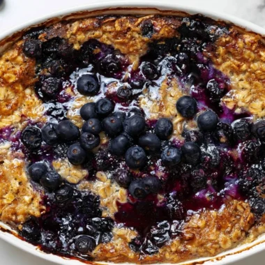 Cozy blueberry baked oatmeal served in a bowl with fresh blueberries on top