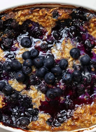 Cozy blueberry baked oatmeal served in a bowl with fresh blueberries on top
