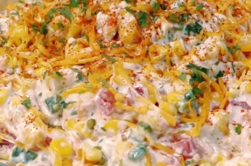 Cozy cold street corn dip served in a bowl with fresh toppings