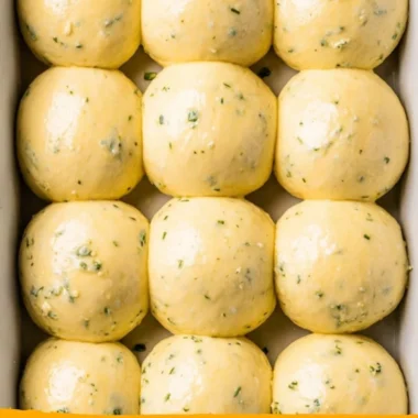 Freshly baked cozy garlic bread rolls on a wooden table