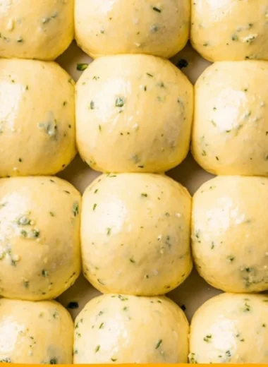 Freshly baked cozy garlic bread rolls on a wooden table