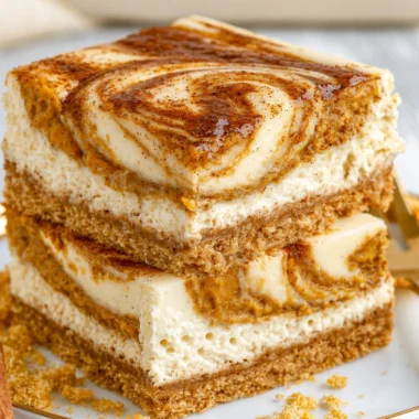 Cozy pumpkin cheesecake bars topped with whipped cream and autumn spices