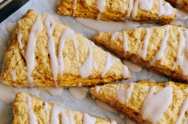 Delicious homemade sourdough pumpkin scones on a wooden table.