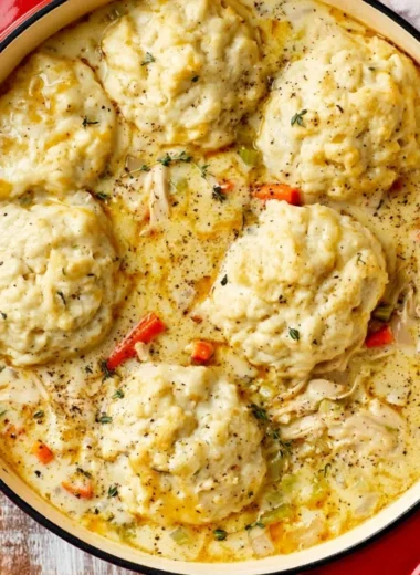 Bowl of creamy homemade chicken and dumplings garnished with parsley