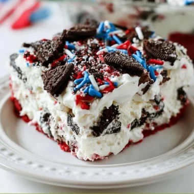 No Bake Fireworks Oreo Cheesecake Bars topped with colorful sprinkles and Oreo crumbs