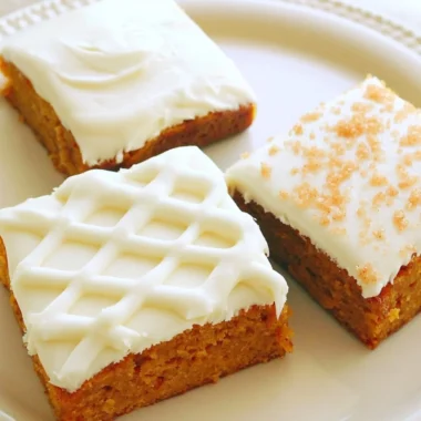 Delicious pumpkin bars with cream cheese frosting on a serving plate.