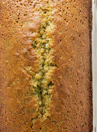 Delicious homemade zucchini bread sliced and served on a wooden cutting board