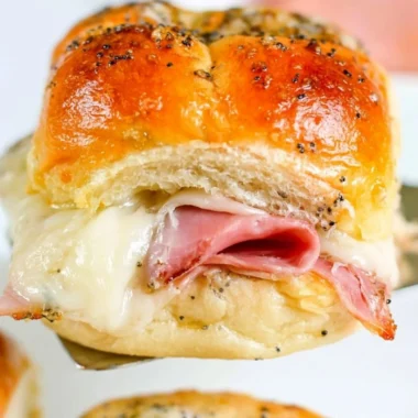Delicious baked ham and cheese sliders on a serving platter