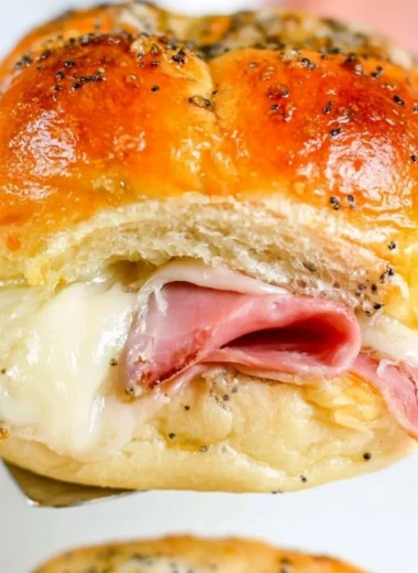 Delicious baked ham and cheese sliders on a serving platter