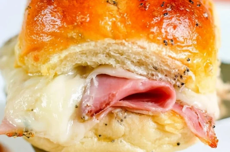 Delicious baked ham and cheese sliders on a serving platter