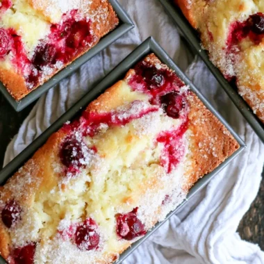 Deliciously baked cozy cranberry quick bread on a wooden table