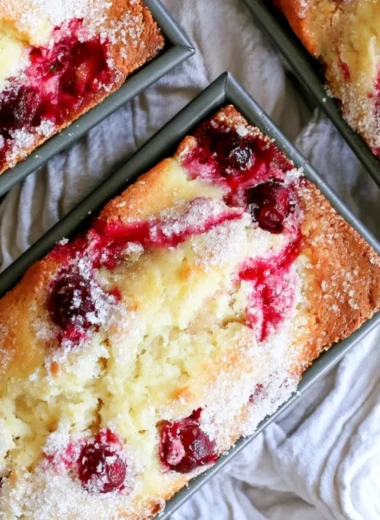 Deliciously baked cozy cranberry quick bread on a wooden table