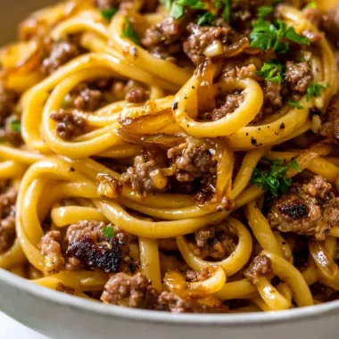 Cozy garlic butter beef pasta served in a bowl garnished with parsley