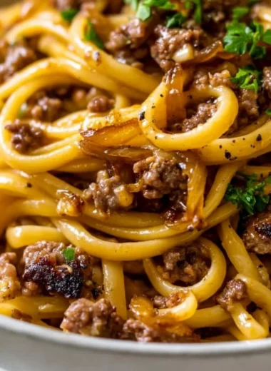 Cozy garlic butter beef pasta served in a bowl garnished with parsley