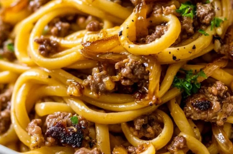 Cozy garlic butter beef pasta served in a bowl garnished with parsley