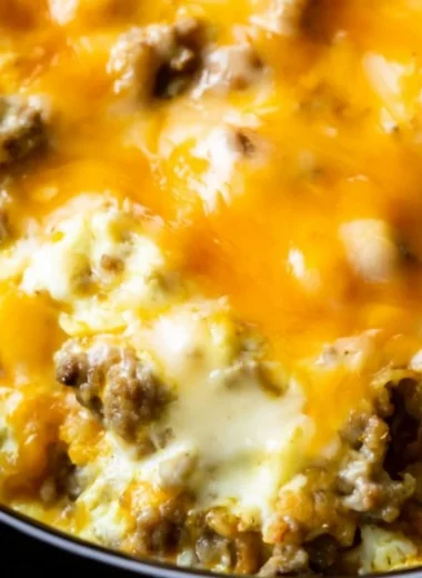 Delicious cheesy sausage hashbrown breakfast plate with toppings