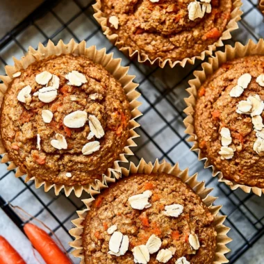Freshly baked cozy Carrot Apple Muffins on a wooden table
