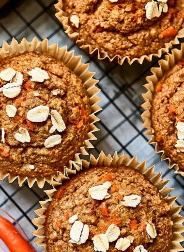 Freshly baked cozy Carrot Apple Muffins on a wooden table