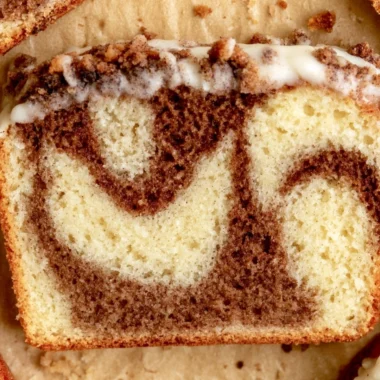 Cozy cinnamon loaf cake topped with a sprinkle of cinnamon.