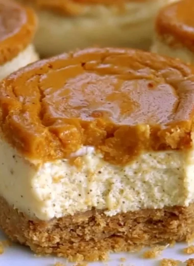 Cozy mini pumpkin cheesecakes topped with whipped cream and autumn spices