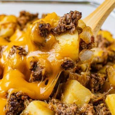 A plate of Hamburger Hash featuring ground beef, potatoes, and vegetables.