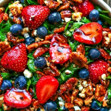 Delicious strawberry spinach salad with blueberries, pecans, and feta cheese.