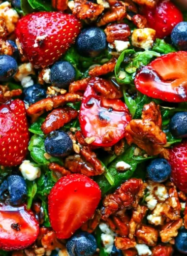Delicious strawberry spinach salad with blueberries, pecans, and feta cheese.