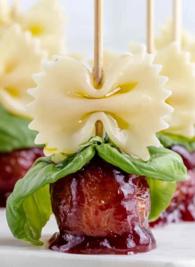 Bowtie pasta and cocktail meatball skewers on a serving platter