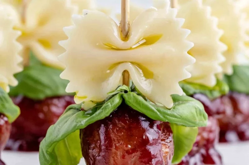 Bowtie pasta and cocktail meatball skewers on a serving platter