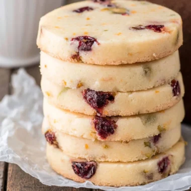 Cranberry Pistachio Shortbread cookies arranged on a festive plate