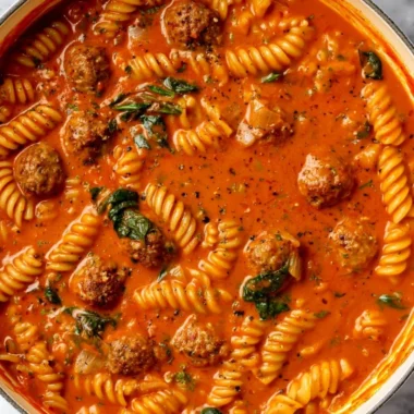 Bowl of creamy Italian Meatball Soup garnished with herbs and spices