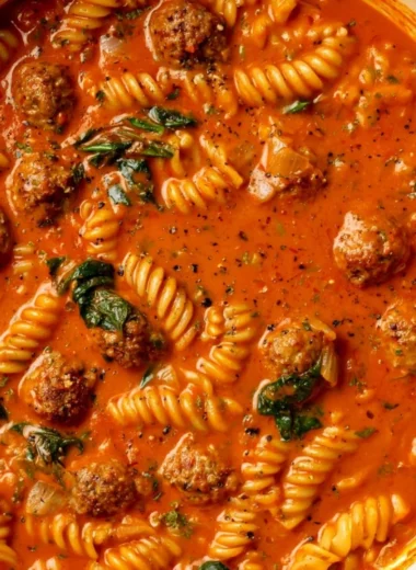 Bowl of creamy Italian Meatball Soup garnished with herbs and spices