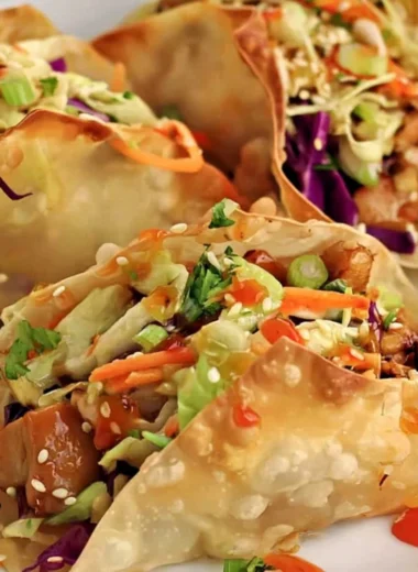 Crispy chicken wonton tacos served with fresh toppings and dipping sauce