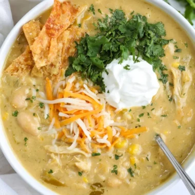 Bowl of easy green enchilada chicken soup garnished with cilantro and lime