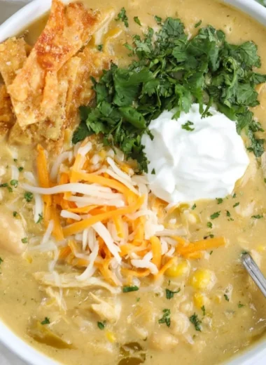 Bowl of easy green enchilada chicken soup garnished with cilantro and lime