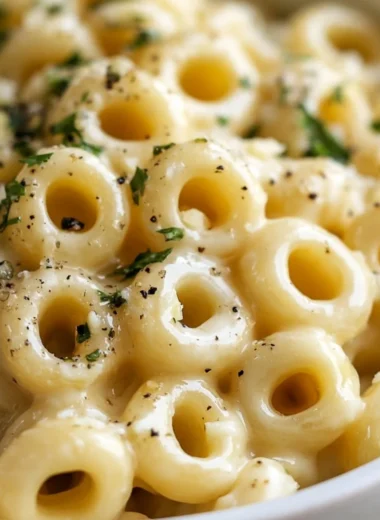 Delicious garlic butter pasta dish topped with herbs and garnishes