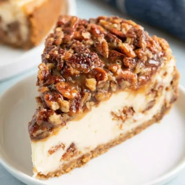 Deliciously baked Pecan Pie Cheesecake topped with pecans