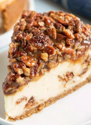 Deliciously baked Pecan Pie Cheesecake topped with pecans